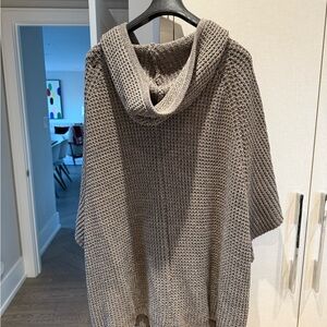 Sweater poncho with tortoise toggles.